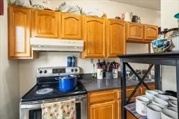 a kitchen with stainless steel appliances granite countertop a stove and cabinets