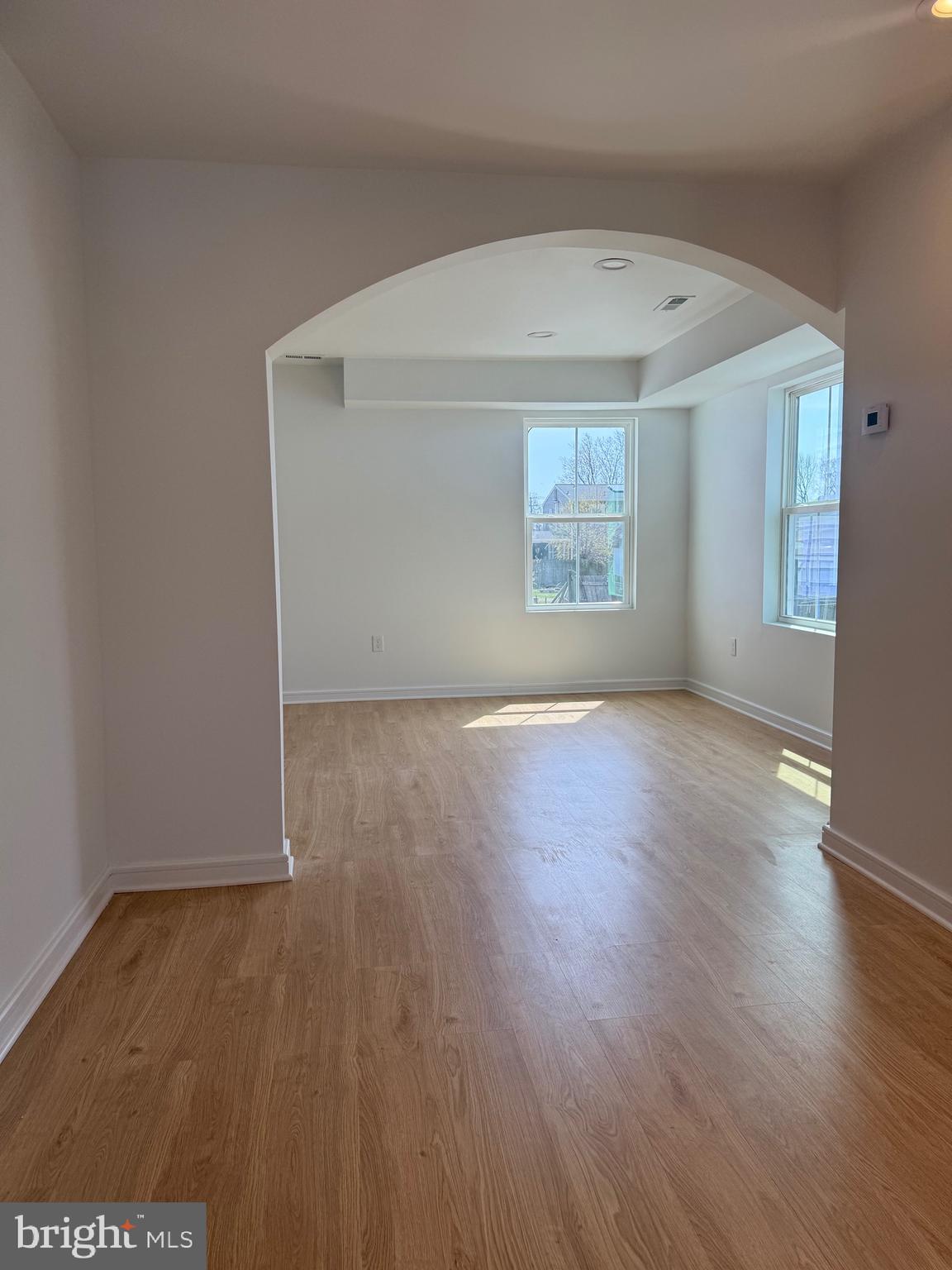 2125 Oakland Road Middle River, MD 21220 - Photo 6 of 15 an empty room with wooden floor and windows