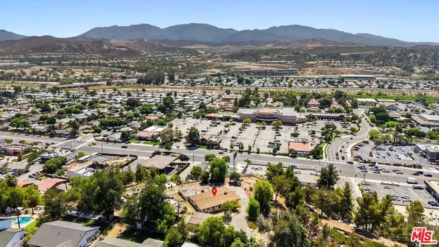 an aerial view of residential house with parking and mountain view