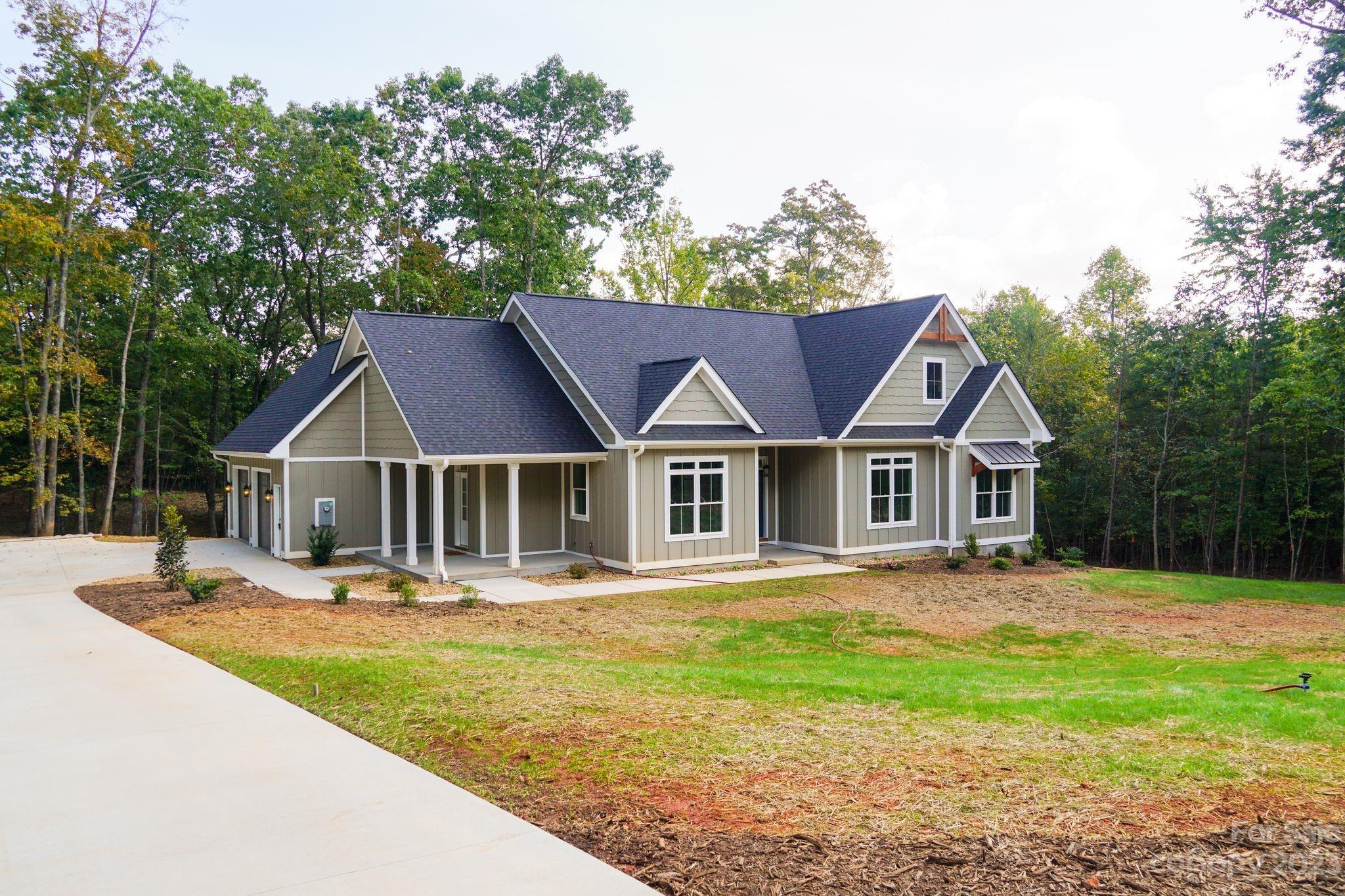 1495 Golf Course Road Columbus, NC 28722 - Photo 13 of 47 a front view of a house with a yard