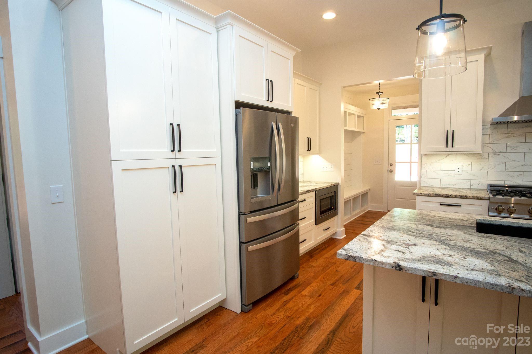 1495 Golf Course Road Columbus, NC 28722 - Photo 15 of 47 a kitchen with granite countertop a refrigerator and a sink