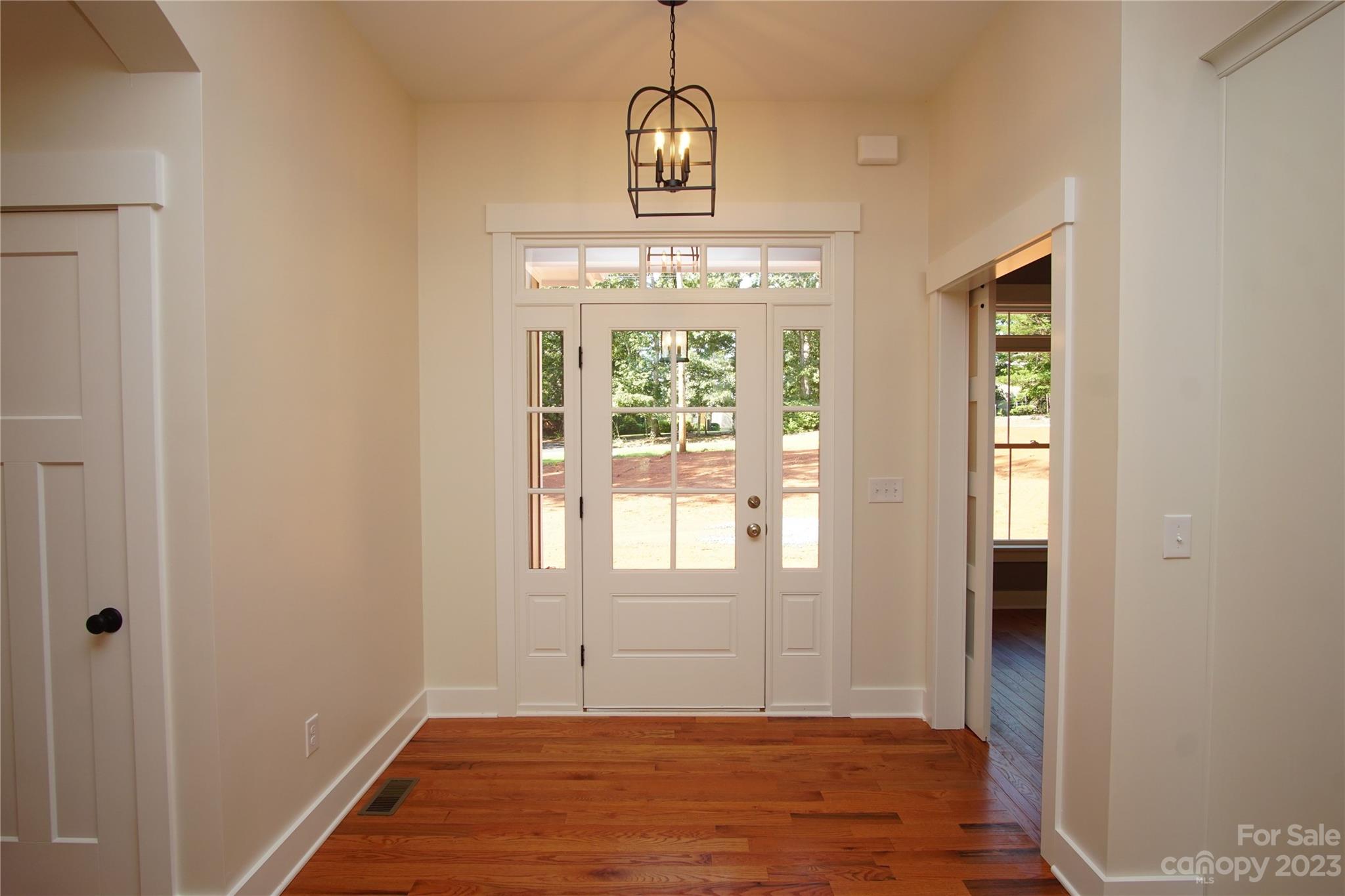 1495 Golf Course Road Columbus, NC 28722 - Photo 22 of 47 a view of an empty room with wooden floor and a window