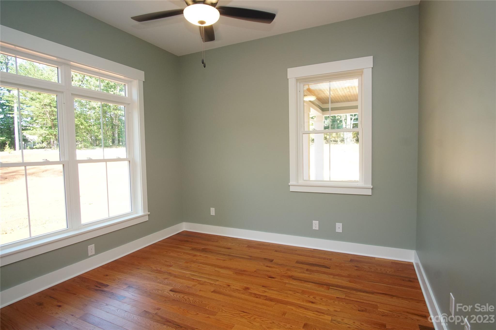 1495 Golf Course Road Columbus, NC 28722 - Photo 27 of 47 a view of an empty room with wooden floor and a window