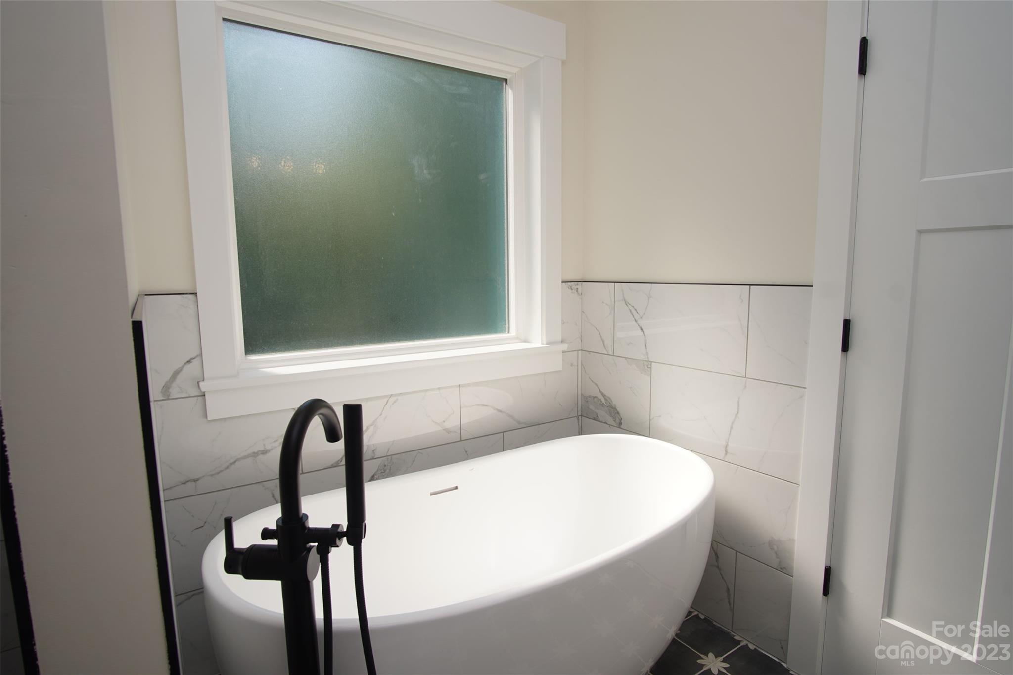 1495 Golf Course Road Columbus, NC 28722 - Photo 32 of 47 a bathroom with a bathtub