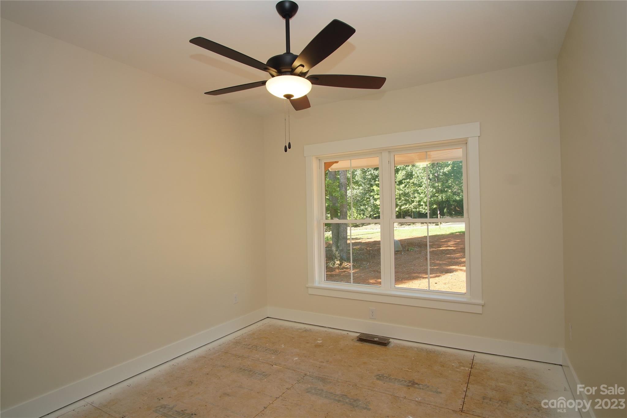 1495 Golf Course Road Columbus, NC 28722 - Photo 37 of 47 an empty room with a window and a fan