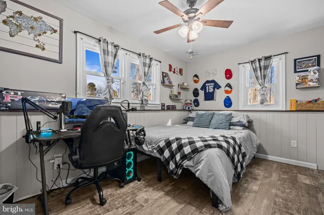 a bedroom with bed and a chandelier