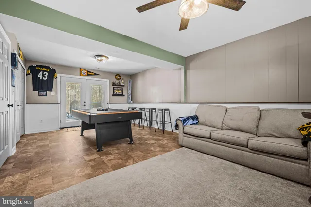 a living room with furniture and a chandelier