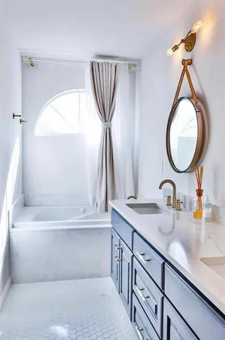 a bathroom with a sink a mirror and a bathtub