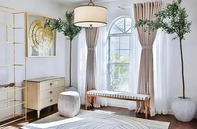 a view of a bedroom with furniture and a window