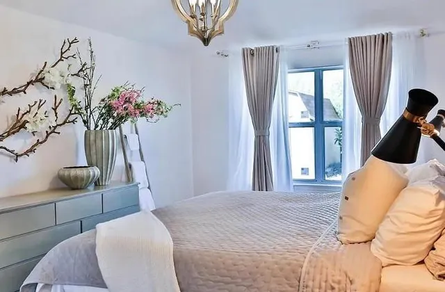 a bedroom with a bed and a potted plant