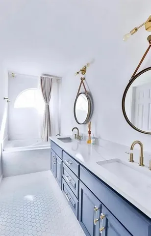 a bathroom with a double vanity sink and a mirror
