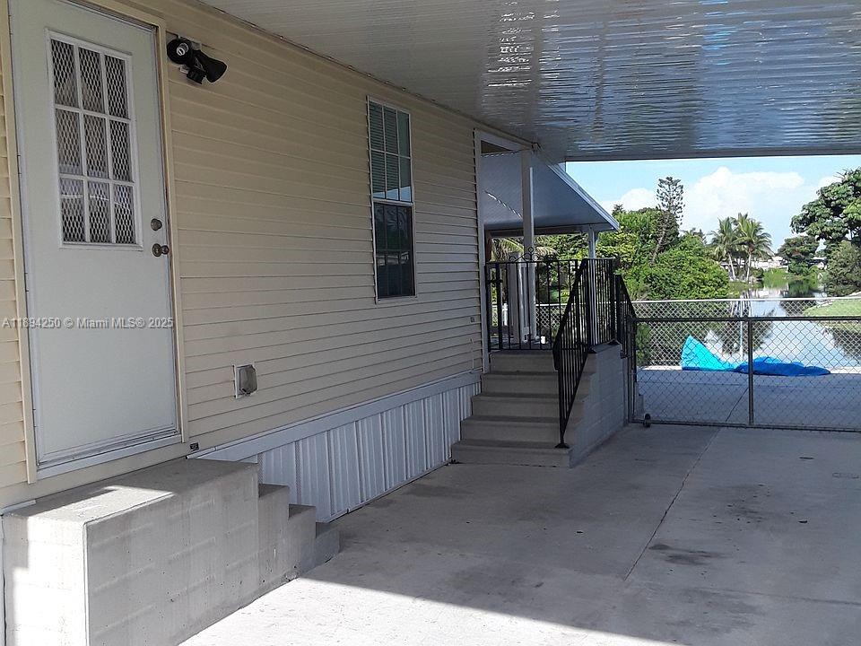 a view of a porch with wooden floor and stairs