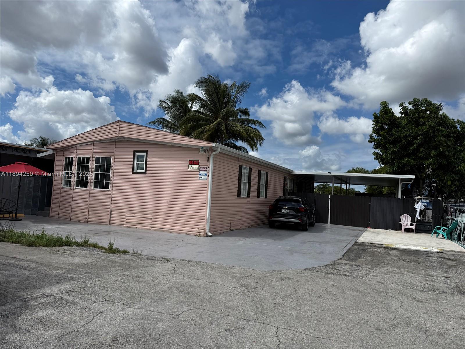 1458 Southwest 127th Court Miami, FL 33184 - Photo 2 of 2 a view of a house with a yard and garage