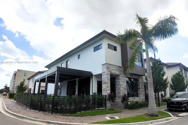 a front view of a house with yard and green space