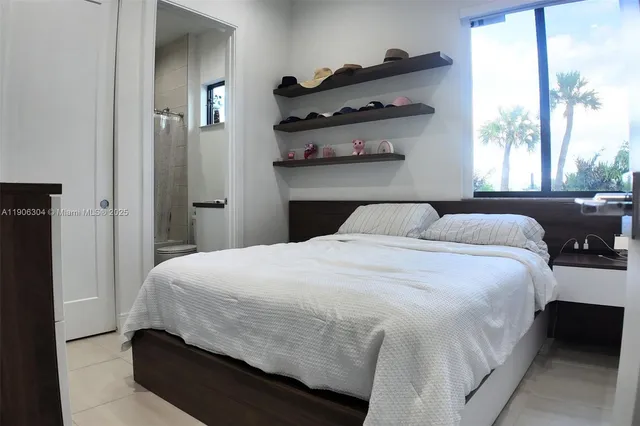 a bedroom with a bed and window