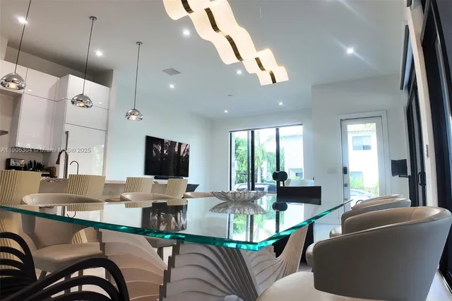 a living room with furniture and large windows