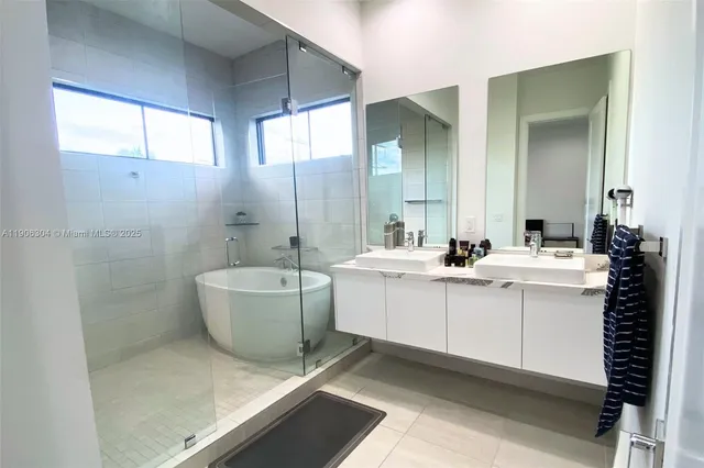 a bathroom with a sink mirror toilet and bathtub