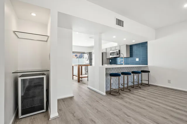 a kitchen with sink and chairs