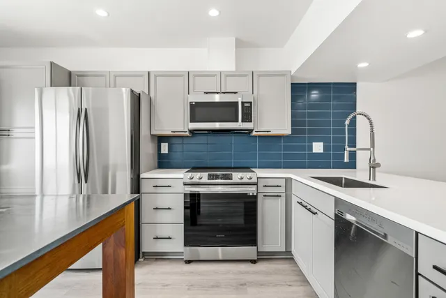 a kitchen with a stove microwave and sink