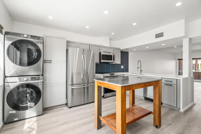 a view of a storage and utility room with a washer dryer