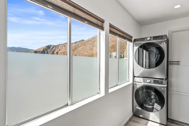 a bedroom with a bed and a large window