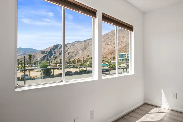 an empty room with wooden floor and closet