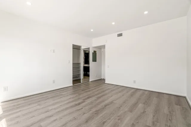a view of walk in closet with empty racks
