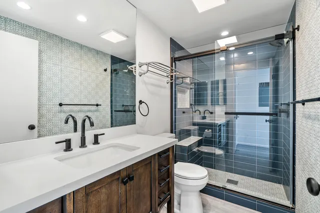 a bedroom with bed and a large window