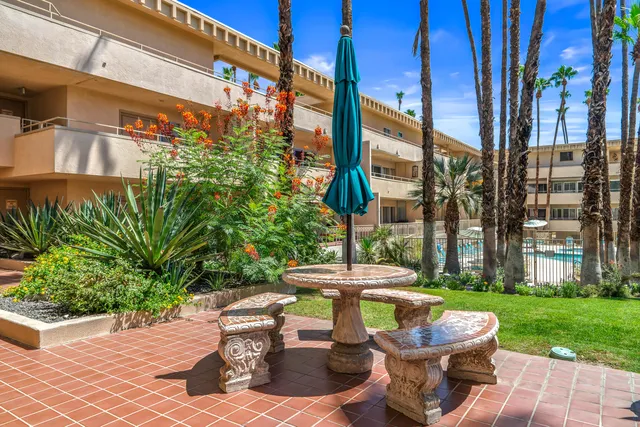 a view of a house with a yard and sitting area