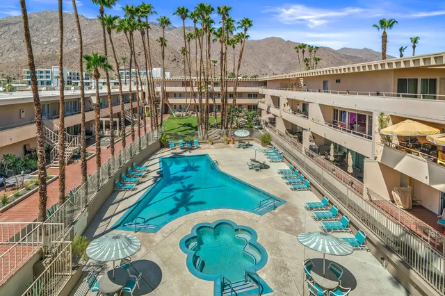 a swimming pool with outdoor seating and city view