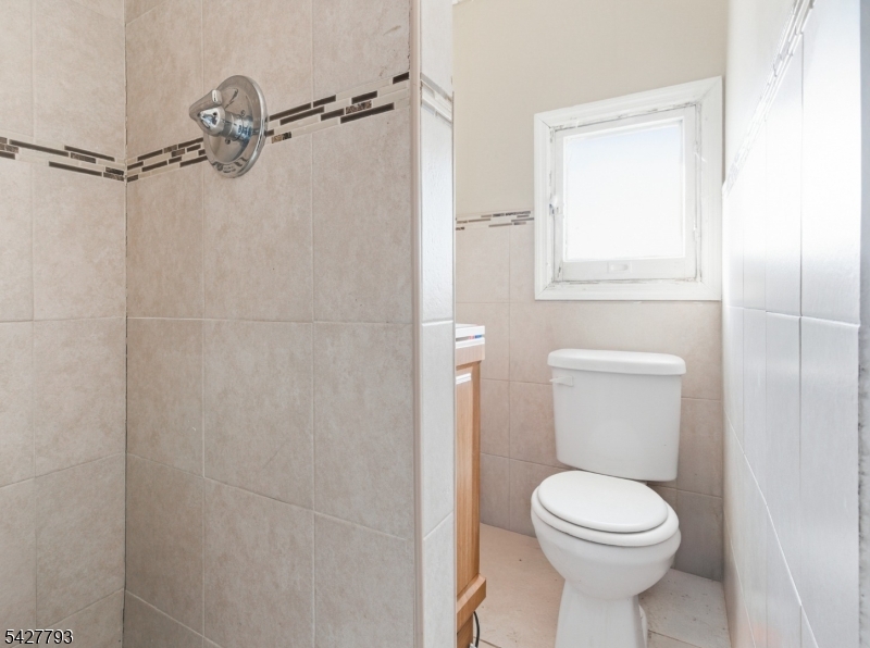 420 Mechanic Street Orange, NJ 07050 - Photo 7 of 18 a bathroom with a toilet and a shower