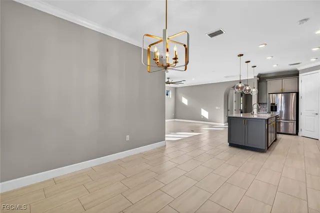 a view of a kitchen with a sink and refrigerator