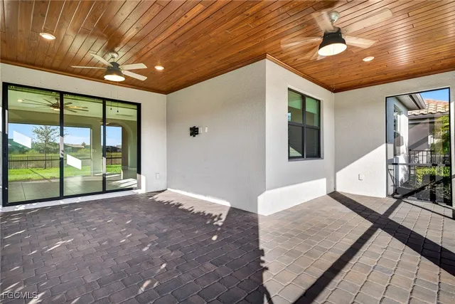a view of an empty room with a fireplace and a chandelier