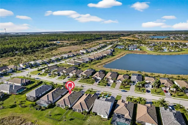 a view of a house with backyard and sitting area