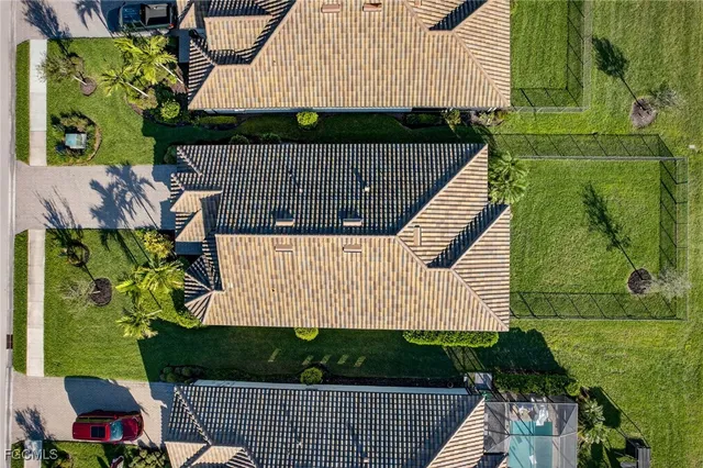 a room with lots of tables a large window and chairs