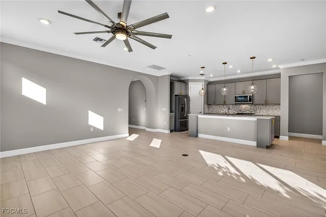 a view of a kitchen with a sink stainless steel appliances and cabinets