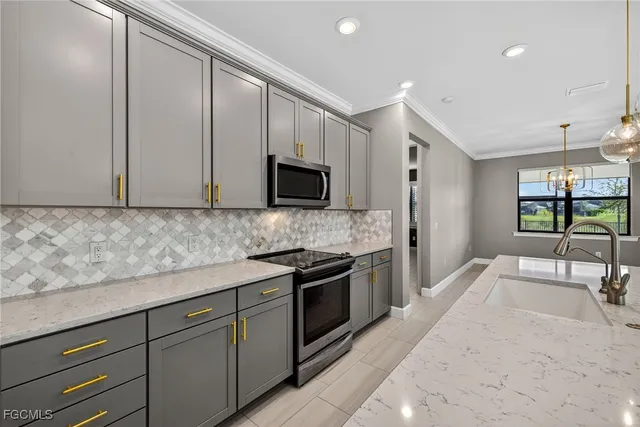 a kitchen with granite countertop white cabinets and stainless steel appliances