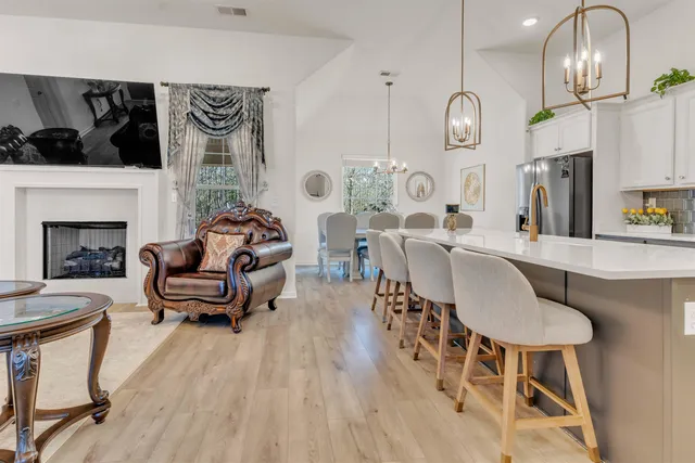 a living room with furniture a fireplace and a flat screen tv