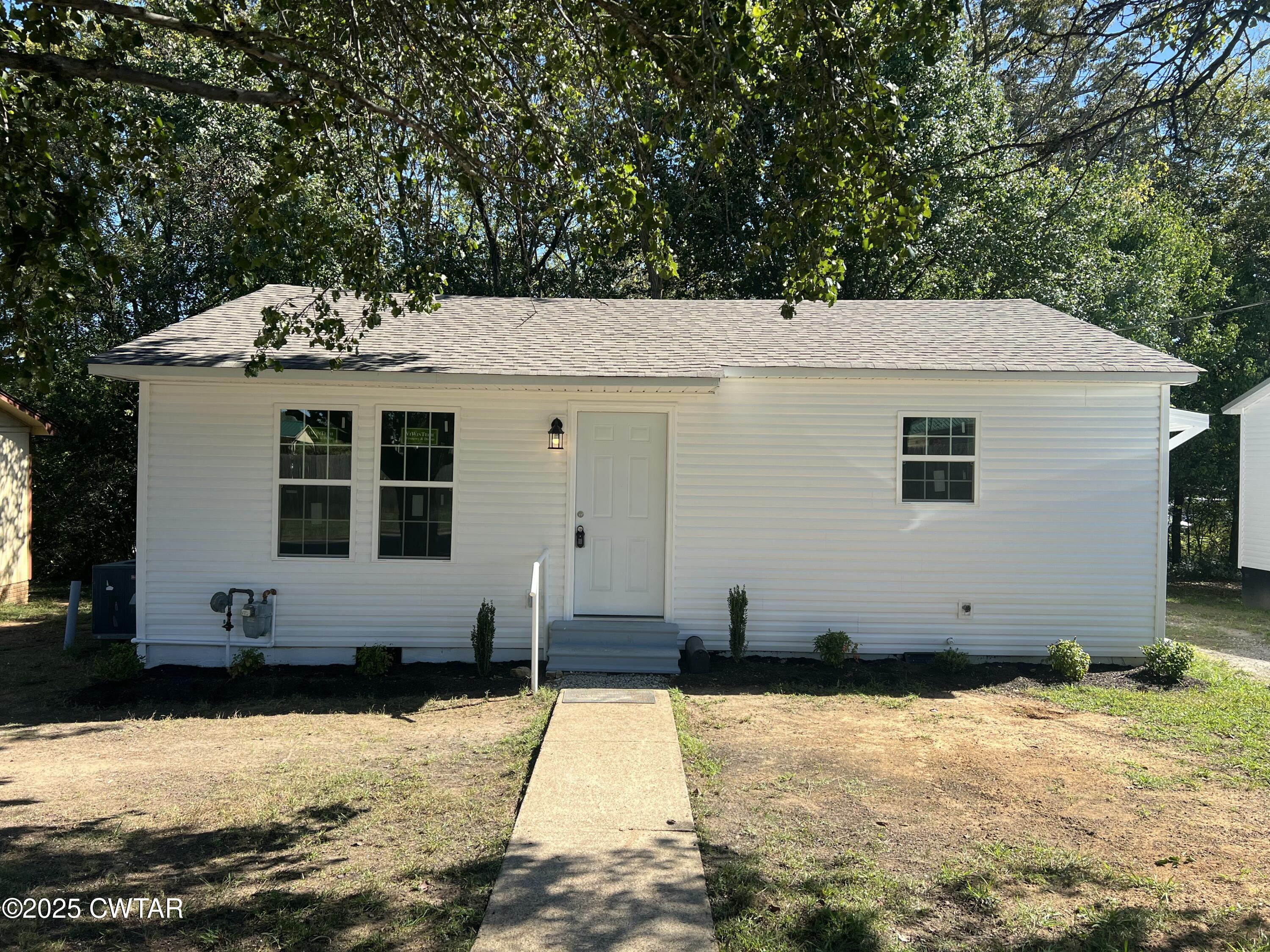 328 Baughn Street Henderson, TN 38340 - Photo 1 of 16 a house with trees in the background