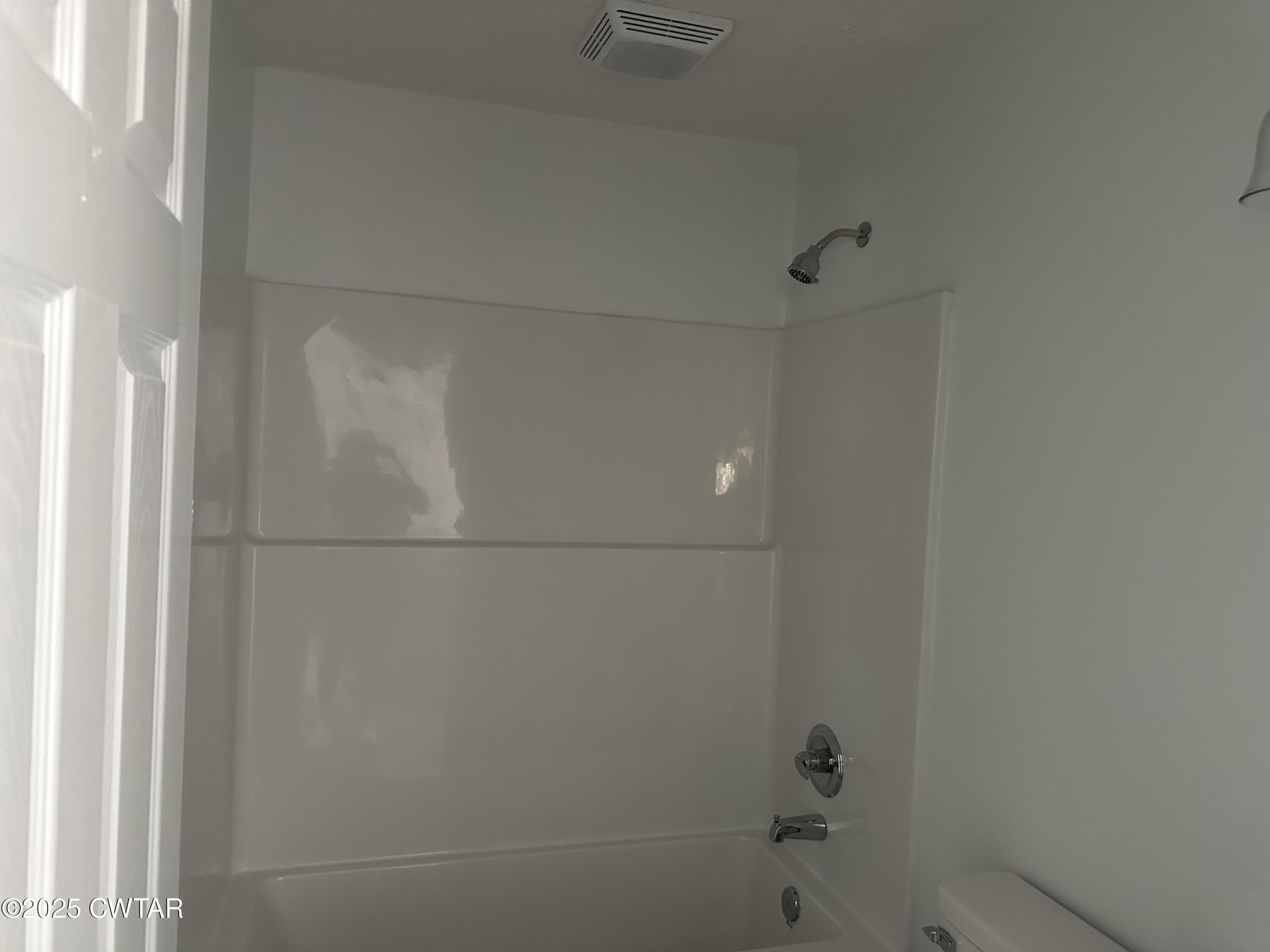 328 Baughn Street Henderson, TN 38340 - Photo 14 of 16 a bathroom with a bathtub