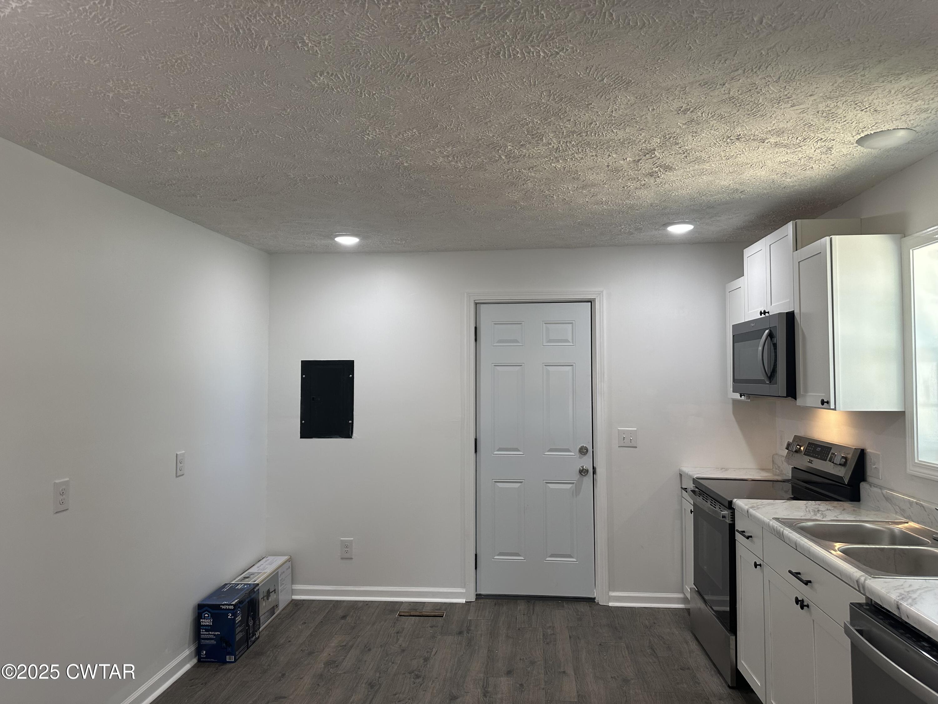 328 Baughn Street Henderson, TN 38340 - Photo 3 of 16 a kitchen with a sink and a stove top oven