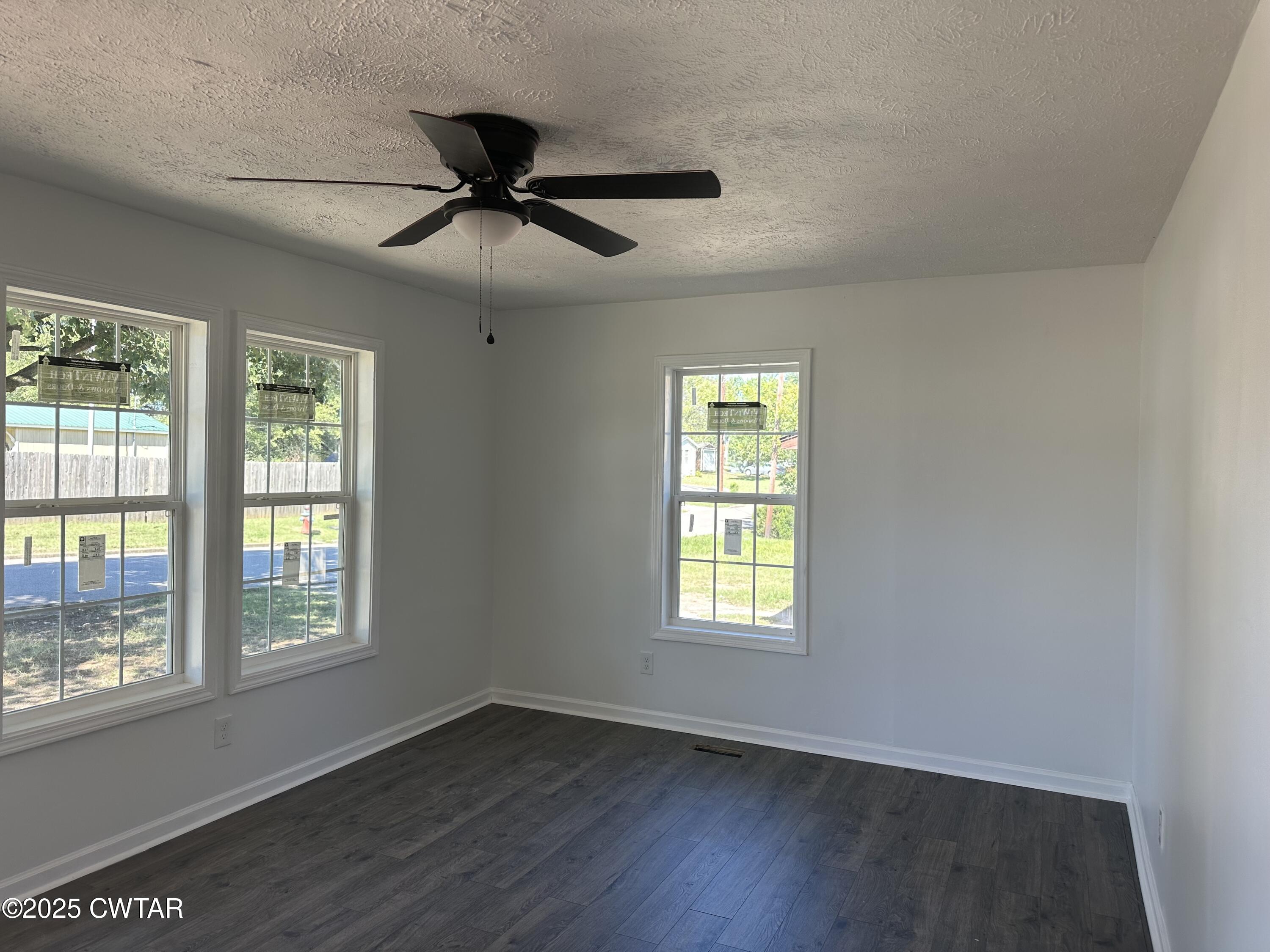 328 Baughn Street Henderson, TN 38340 - Photo 5 of 16 a view of an empty room with wooden floor and a window
