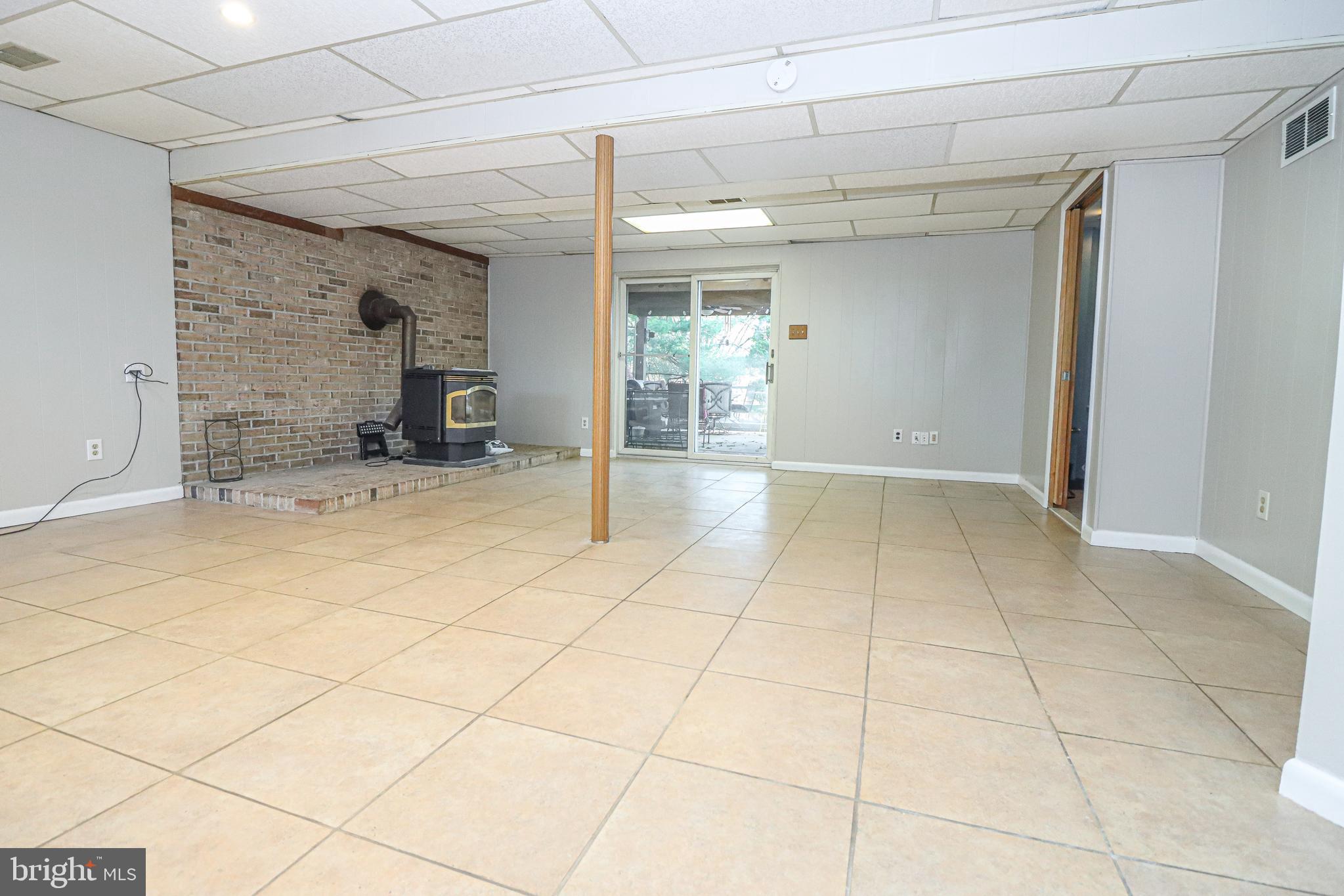 5929 Snowdens Run Road Sykesville, MD 21784 - Photo 25 of 54 Finished basement with a wood stove