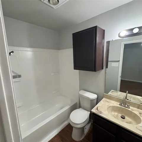 a bathroom with a toilet sink and shower