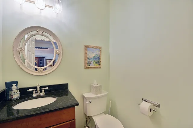 a bathroom with a toilet a sink and a mirror