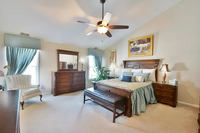 a bedroom with a bed dresser and a window