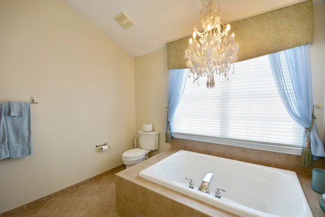 a bath tub sitting in a bathroom next to a window