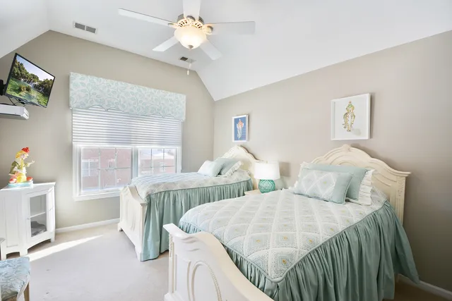 a bedroom with two beds and a window