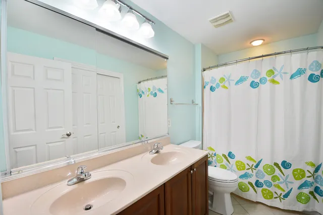 a bathroom with a sink mirror vanity and toilet