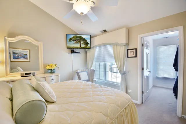 a bedroom with a bed and chandelier